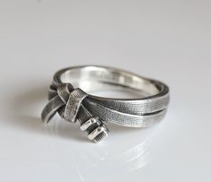 a close up of a silver ring on a white surface