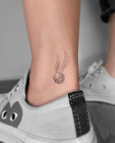 a woman's foot with a small tattoo on the side of her leg,