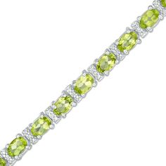 Dazzle and delight on her August birthday with this fresh gemstone bracelet. Crafted in sterling silver, this tennis style features 6.0 x 4.0mm oval-shaped spring-green peridot alternating with beaded and sparkling diamond-accented links. Buffed to a brilliant luster, this beautiful 7.25-inch bracelet secures with a box clasp. Green Oval Tennis Bracelet As Gift, Classic Green Oval Tennis Bracelet, Green Oval Tennis Bracelet For Gift, Tennis Style, August Birthday, Peridot Jewelry, Peridot Stone, Box Clasp, Green Peridot