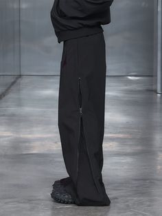 Introducing the Spliced Side Zipper Pants, where contemporary style seamlessly meets intricate details. At first glance, they may appear as standard oversized pants, but a closer inspection reveals a realm of innovative features. Expertly crafted with futuristic lines through splicing techniques, the pants incorporate luxe faux leather patches, epitomizing sophistication. The dual zippers running almost up to the hip height on both sides not only exude a modern aura but also offer versatility, a Side Zipper Pants, Pants With Zippers, Oversized Pants, Zipper Pants, Pants Details, The Hundreds, Leather Patches, Intricate Details, Male Model