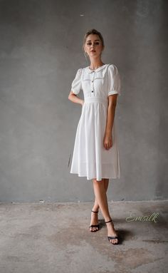 "This design linen dress is perfect for summer and fall! 100 % designed and handmade by Emsilk. I am pleased to offer your garments made to measure at no extra cost. * Detail: - Collared neckline - Coconut buttons on the front - Small gathered decoration on the front - Fit and flare bottom - Fully lined - Invisible zipper on the back - Below the knee length - High quality linen, washed linen, soft linen - The model is 5'6\" tall and wearing size S. * Care: - Dry clean or machine washed with cold White Puff Sleeve Vintage Dress For Summer, Cottagecore Dresses With Gathered Sleeves For Daywear, White Short Sleeve Vintage Summer Dress, White Short Sleeve Vintage Dress For Summer, White Vintage Dress With Short Sleeves For Summer, Summer White Vintage Dress With Short Sleeves, Summer Workwear Puff Sleeve Dress With Gathered Sleeves, Modest Short Sleeve Puff Sleeve Dress, Elegant Vintage Short Sleeve Summer Dress