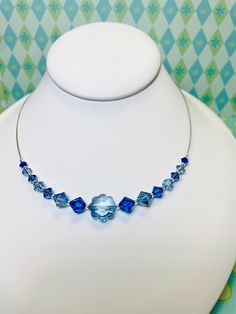 "16\" sapphire and light sapphire blue vintage Swarovski Crystal flower necklace. \"centerstage\" style necklace has alternating, shapes ad shades of aapphirr blue. Clustered front with sides on nylon coated beading wire. 16\" long w 2\" extender. Sterling clasp. Sterling silver lobster claw clasp with 2\" extender.  Coordinating earrings available. Sold separately. Limited edition. Great gift! Suitable for all occasions and perfect gift for women. Arrives in gift box ready for giving.  Great formal wear, prom, weddings, cruise wear, semi formal. Mother's Day, Birthday, any occasion for small gift. Arrives in gift box ready for gifting." Blue Crystal Necklaces For Wedding, Blue Crystal Necklace For Wedding, Adjustable Blue Necklace For Anniversary, Necklace Formal, Blue Flower Necklace, Formal Necklace, Teal Necklace, Swarovski Pearl Necklace, Prom Necklaces