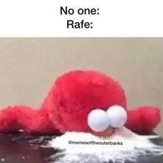 a red stuffed animal laying on top of a table next to a sign that says no one rate