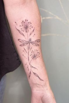 a woman's arm with a flower tattoo on it