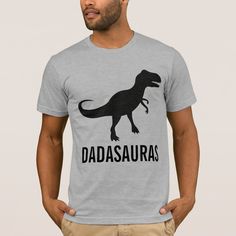 a man wearing a t - shirt with the word dadasauras printed on it