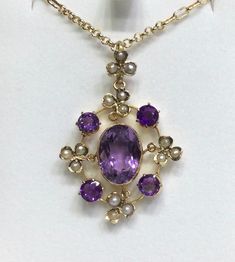 Amethyst & Seed Pearl set in 9ct yellow gold  Edwardian/Victorian era  Pendant size approx 4cm by 2.5cm across  15 seed pearls  4 round amethyst approx 0.40ct size  Oval 10mm across by 12mm  Chain 375 9ct 20inch  lobster catch ( more modern )  If you wish to purchase without the chain please message for a price. Victorian Amethyst Round Jewelry, Antique Round Purple Necklace, Pearl Set, Seed Pearl, Amethyst Pendant, Victorian Era, Signet Ring, Pearl Pendant, Pendant Necklaces