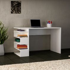 a white desk with a laptop on top of it next to a potted plant