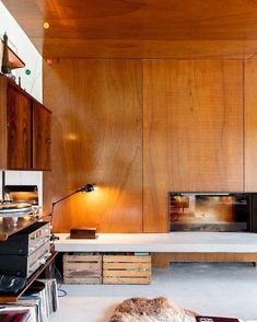 a living room filled with furniture and a flat screen tv on top of a wooden wall