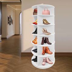 there is a white shelf with many pairs of shoes on it in the hallway next to a door