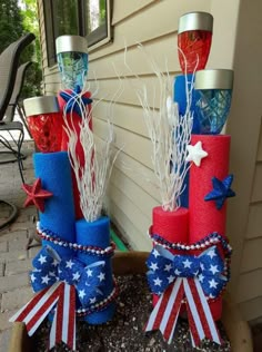 two red, white and blue patriotic decorations in a planter