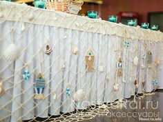 the table is set up with seashells and other decorations on top of it