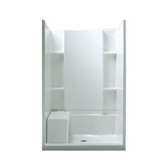 a white bath tub sitting next to a walk in shower with shelves on the wall