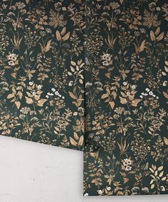 two pieces of wall paper with flowers and leaves on them, one is green and the other is gold