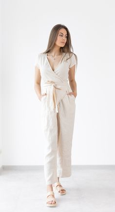 Wrap linen jumpsuit Mila  - relaxed fit linen soft linen jumpsuit / beach jumpsuit. Summer clothing created by MinimalisticLinen DETAILS ----------------- * short sleeves * Wrap jumpsuit * Pockets * Belt * Made from OEKO - TEX Standard 100 certified European linen fabric which guarantees you that it meets human - ecological requirements. * Handmade item. Cut and sewn by professionals in our family studio.  FIT ----------------- * Relaxed fit IMAGES ----------------- * Model is wearing XS/S * Please note that colors can slightly mismatch from pictures due to factors that are beyond our control like your display settings, device you are using etc. CARE INSTRUCTIONS ----------------- * Machine wash in cold water up to 30ºC/86ºF gentle cycle * Dry on low heat or hang to dry for best results. * Beige Linen Casual Jumpsuits And Rompers, Beige Linen Jumpsuits And Rompers For Loungewear, Chic Linen Jumpsuits And Rompers With Tie Waist, Linen V-neck Jumpsuits And Rompers For Spring, Spring Linen V-neck Jumpsuit, Spring Linen Jumpsuit With V-neck, Chic Linen Jumpsuits And Rompers With Short Sleeves, Spring Fitted Linen Jumpsuits And Rompers, Fitted Linen Jumpsuits And Rompers For Spring