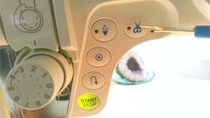 a sewing machine with buttons and needle in it