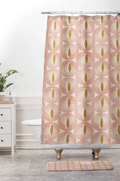 a pink shower curtain with gold circles on it