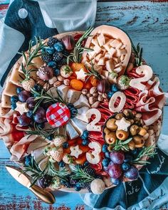 a platter filled with lots of different types of food on top of a table