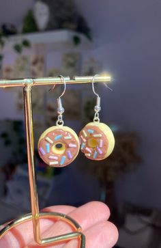 a pair of earrings that have donuts on them