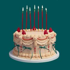 a birthday cake with lit candles on it