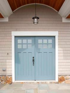 the front door is painted blue with white trim