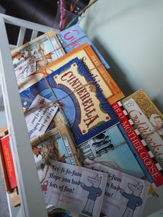 several books are stacked on top of each other in a book shelf next to a ladder