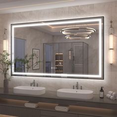 a bathroom with two sinks and a large mirror over it's counter top area