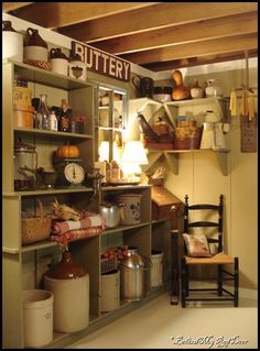 an old fashioned kitchen with many items on the shelves