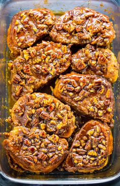 sweet potato casserole with pecans in a glass baking dish on a blue surface