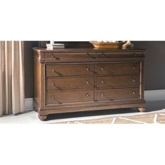 the dresser is brown and has many drawers