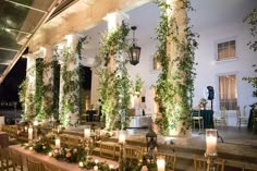 an outdoor wedding venue with candles and greenery