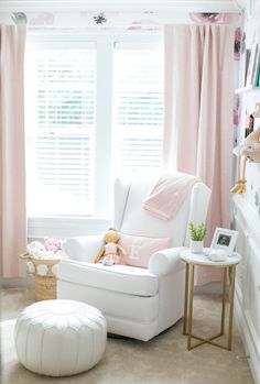 a baby's room with pink curtains and white furniture