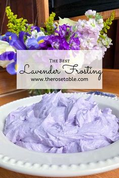 lavender frosting in a white bowl on a table with purple flowers and the words, the best lavender frosting