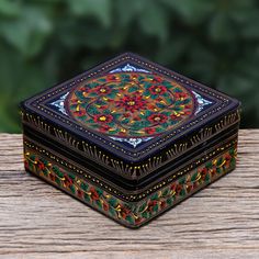 a decorative box sitting on top of a wooden table