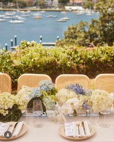 the table is set with white and blue flowers