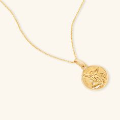 This coin necklace featuring St. Michael is a beautiful layering piece that will make you look vacation-ready year round. - Solid 14k gold coin - 14mm profile diameter - Delicate 16 inch or 18 inch gold chain