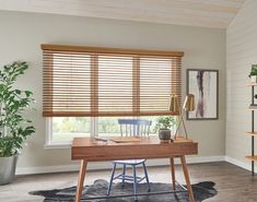 a home office with wooden blinds and desk