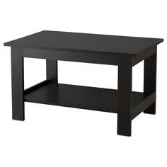 a black coffee table sitting on top of a white floor