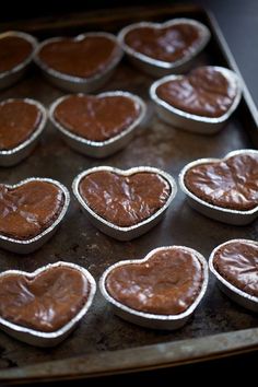 heart shaped cupcakes on a baking tray ready to be baked in the oven