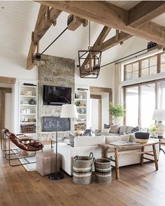 a living room with wooden beams and white furniture in the center is featured on instagram