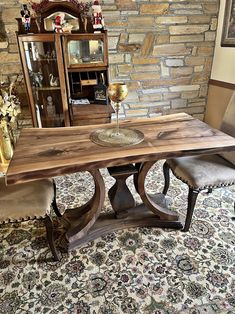 a wooden table sitting on top of a rug