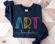 This Floral Art Teacher sweatshirt is the perfect way to show appreciation for your favorite Art educator. Ideal for any Art specials teacher, it's a harmonious blend of style and gratitude, making it an excellent choice for Art Teacher Appreciation gifts. ✨ Please check the SIZE CHART image on the listing, and choose your size accordingly before placing your order.  🚫We do not accept exchanges, returns, or cancellations, however, if there are any print issues with the item please contact us ri Art Teacher Appreciation, Art Sweatshirt, Teacher Sweatshirt, Art Appreciation, Appreciation Gifts, Art Teacher, Teacher Appreciation Gifts, Art Education, Teacher Appreciation