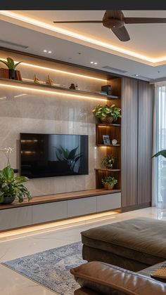 a living room filled with furniture and a flat screen tv mounted on a wall next to a window