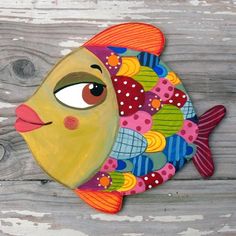 a painting of a fish on a wooden planked wall with the eye looking up