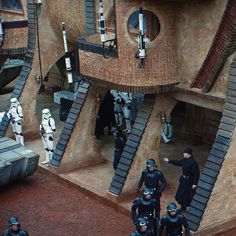 star wars scene with stormtroopers and troopers in front of house made out of cardboard