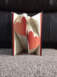 an open book with two hearts cut out of it