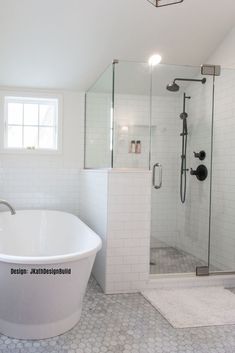 a white bath tub sitting next to a walk in shower