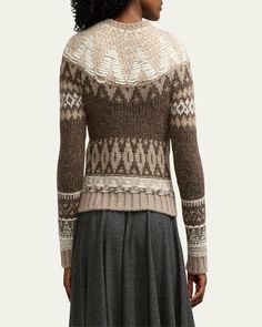 a woman is wearing a sweater with an intricate pattern on the front and back side