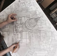 a person is drawing on a large piece of paper