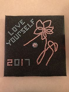 a black square with pink and silver sequins that says, happy new year's eve