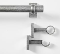 two metal handles and hooks on a white wall